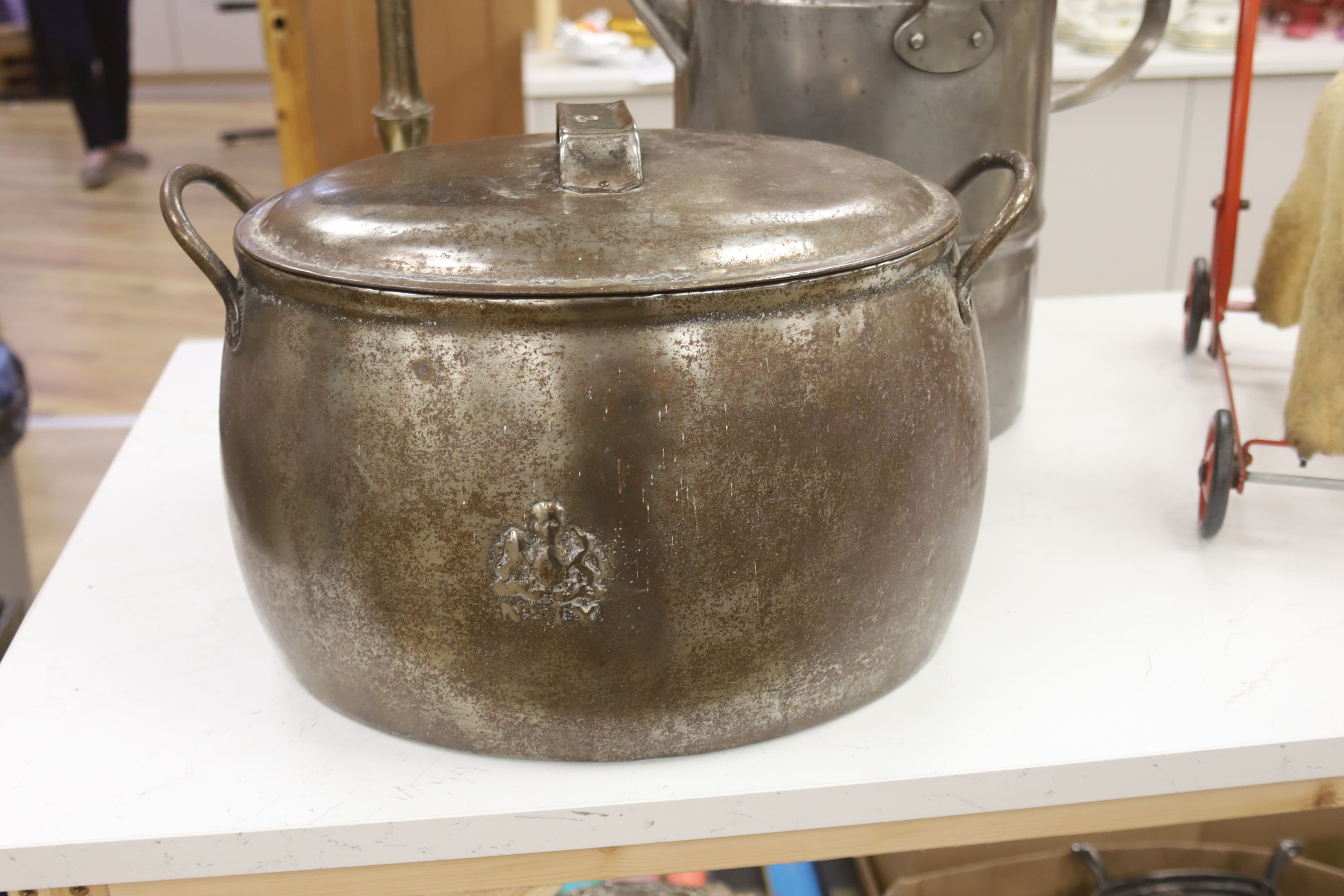 A metal trivet, a lidded pot and a kettle, tallest 43cm